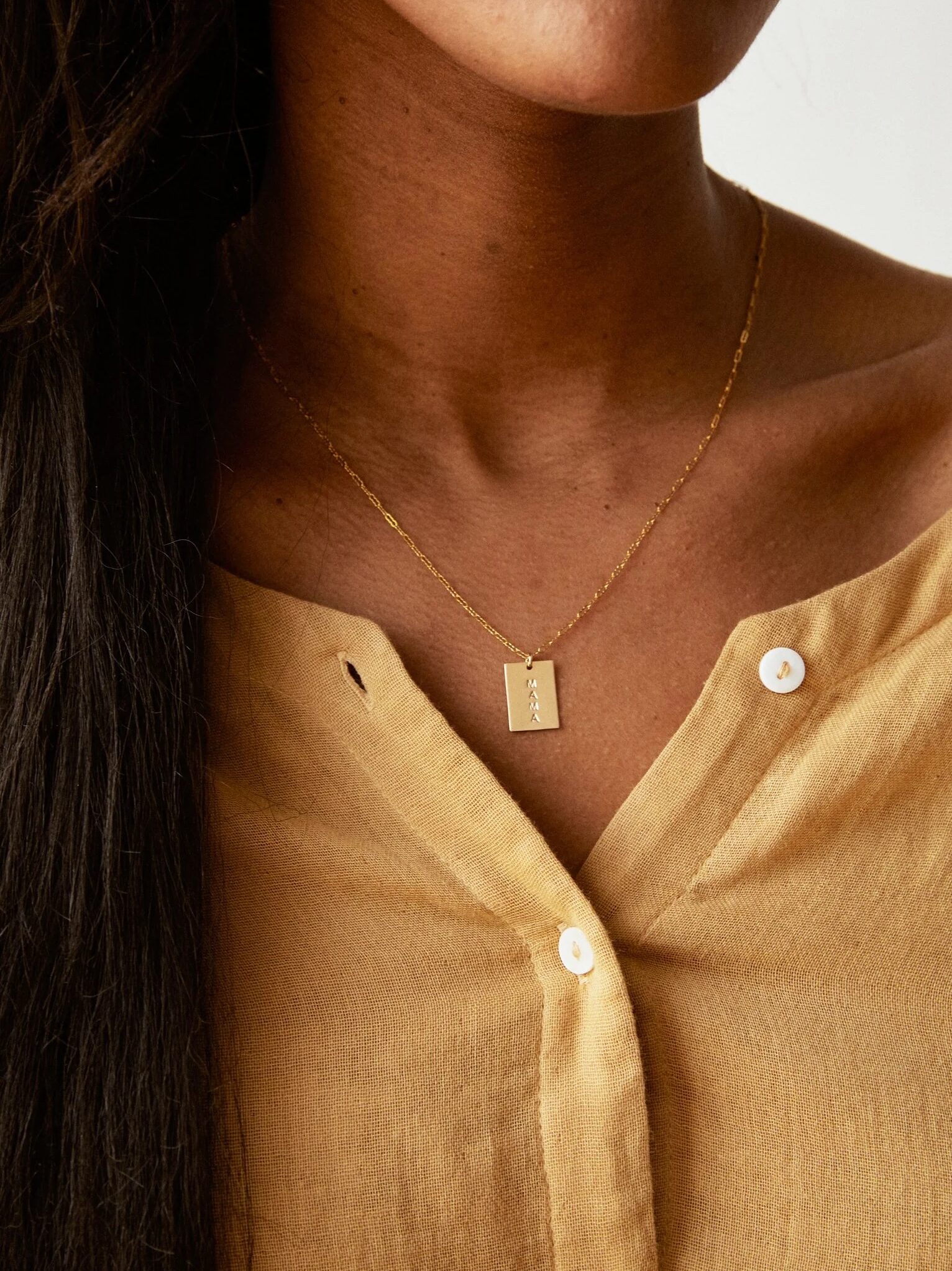 ABLE necklace on a model's neck