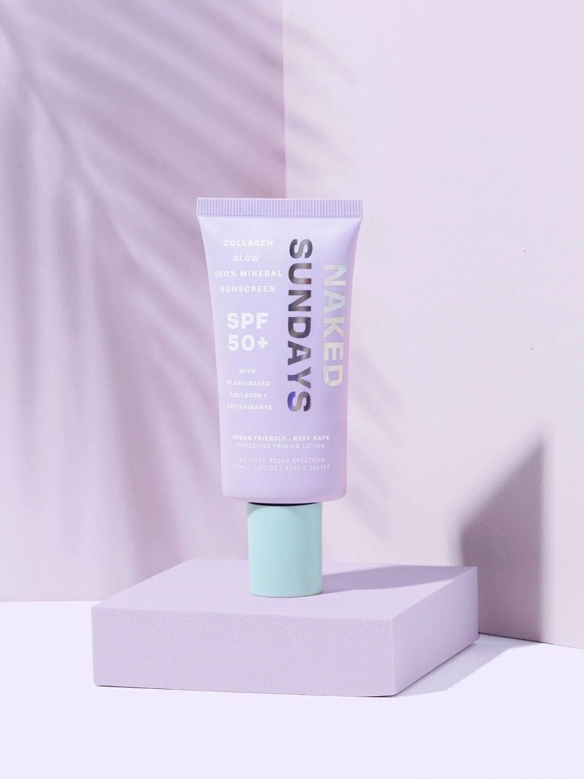 The product is propped on a lavender platform against a lavender background