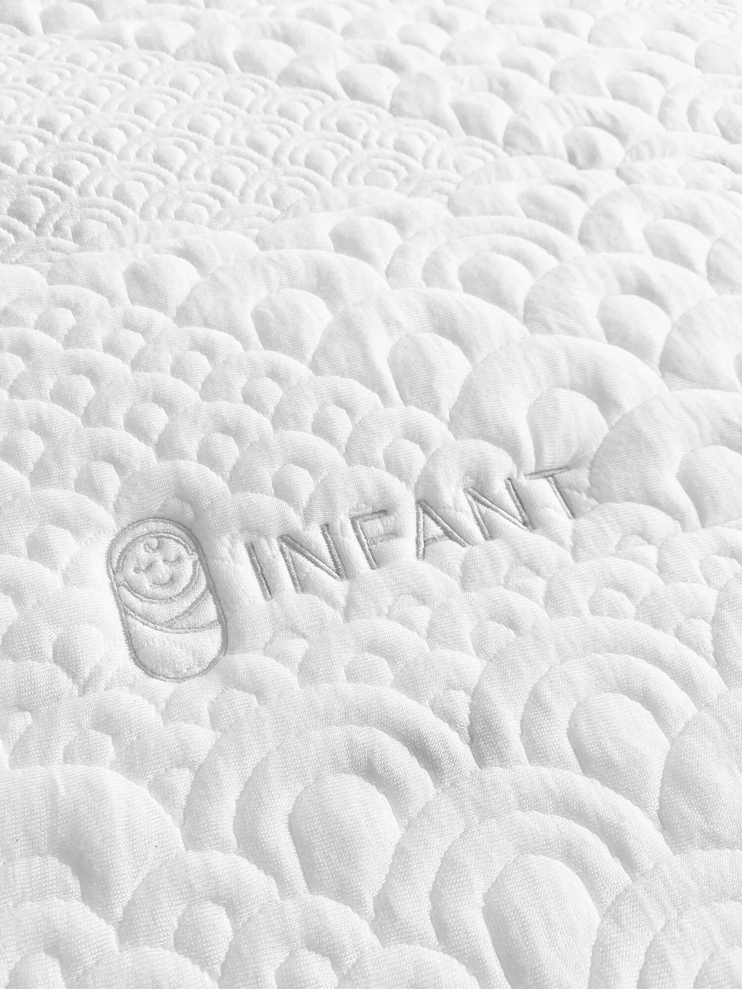 A white quilted mattress cover
