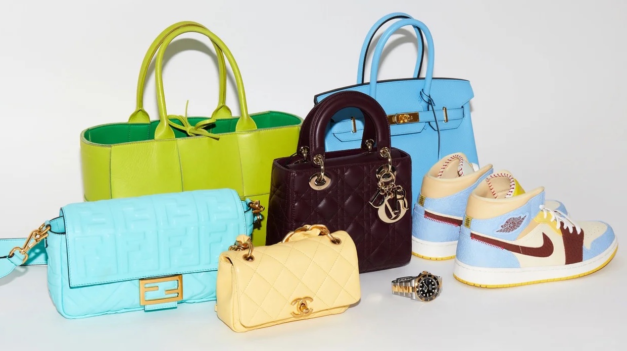 A collection of designer handbags and a watch